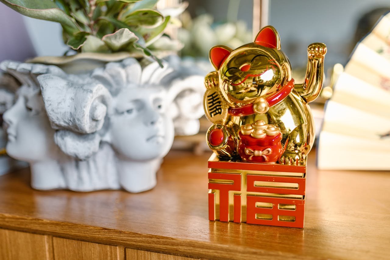 A Golden Lucky Cat figurine symbolizing good fortune and prosperity, displayed indoors.