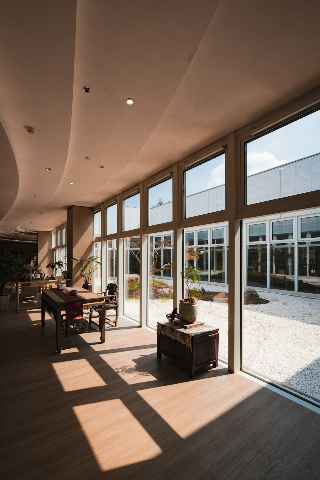 modern-interior-with-large-windows-overlooking-a-zen-garden-43vp96msmto